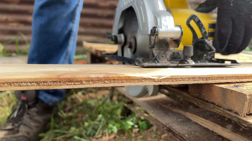 Circular saw cutting through a plywood board on a job site